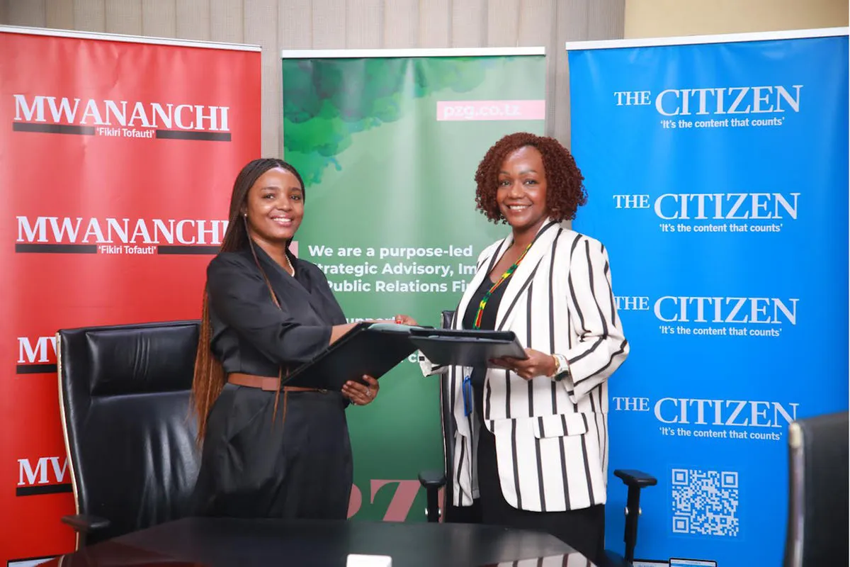 Rosalynn Mworia and Prudence Zoe Glorious exchanging signed MOU documents at Mwananchi Communications offices