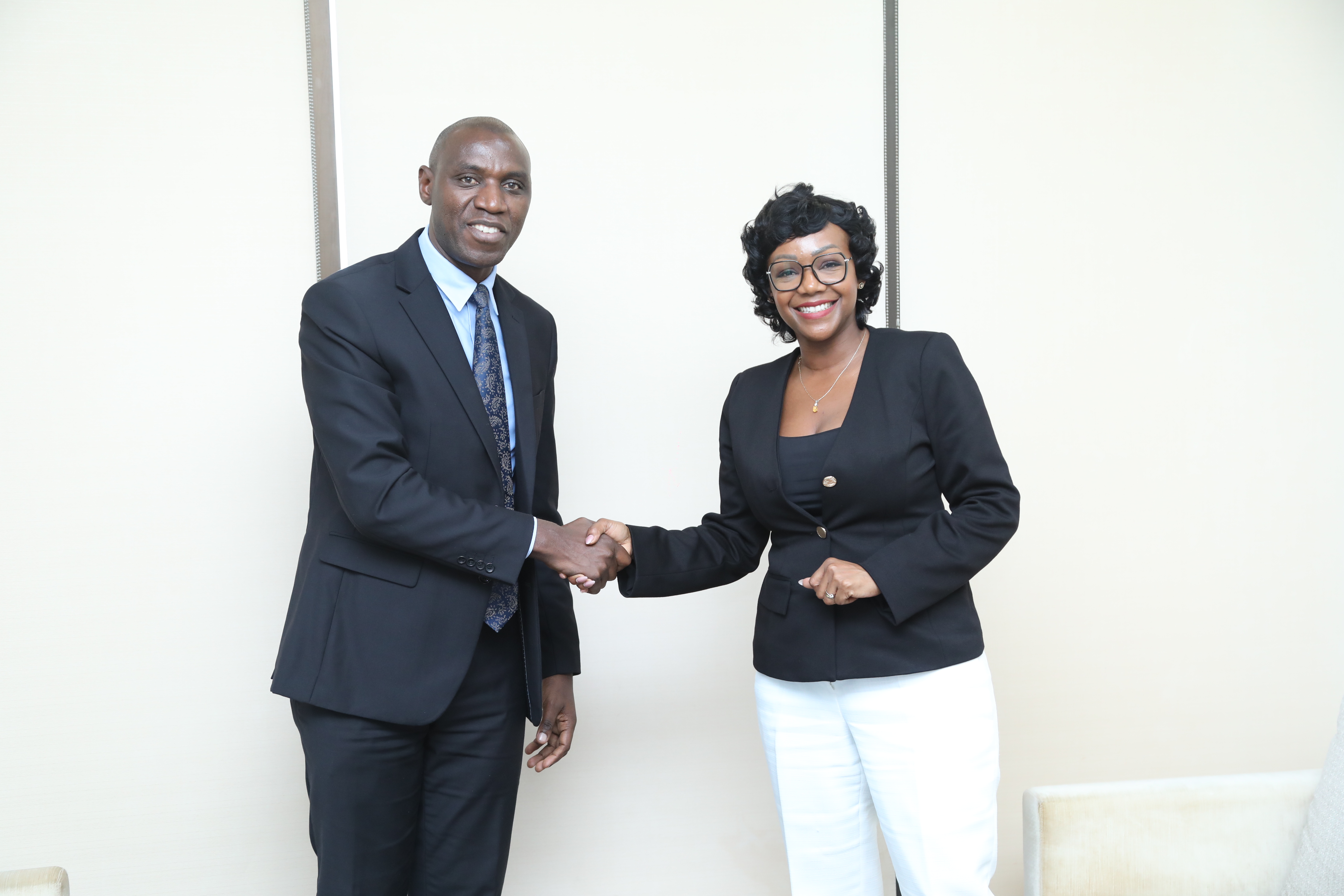 A handshake between Rosalynn Mworia of Mwananchi Communications (Nation Media Group) and Access Bank CEO Imani John, symbolizing cross-sector collaboration.